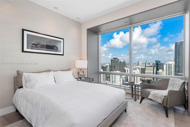 bedroom with hardwood / wood-style flooring