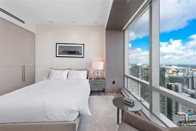 bedroom with hardwood / wood-style flooring and multiple windows