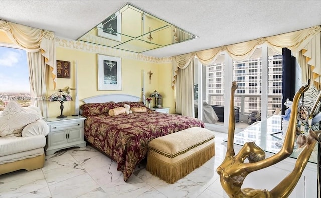 bedroom featuring access to exterior and a textured ceiling