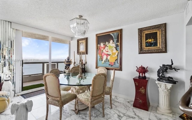 dining area featuring a textured ceiling and a chandelier