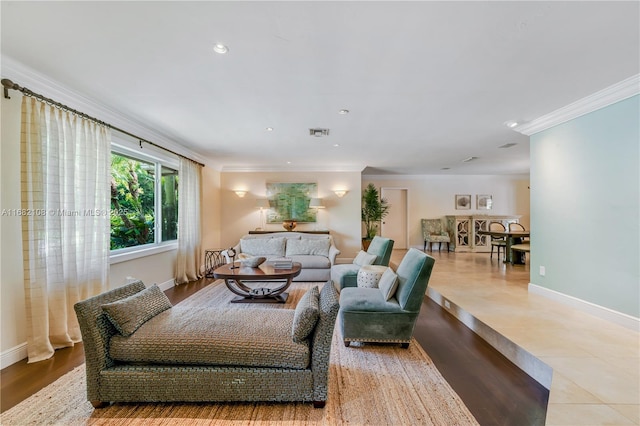 living area with light tile patterned floors, recessed lighting, visible vents, ornamental molding, and baseboards