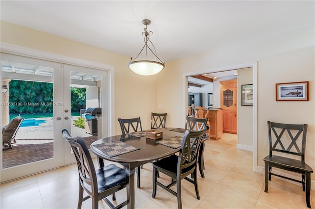 dining area with french doors, light tile patterned flooring, and baseboards