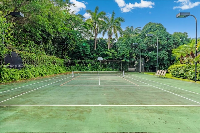 view of tennis court with fence