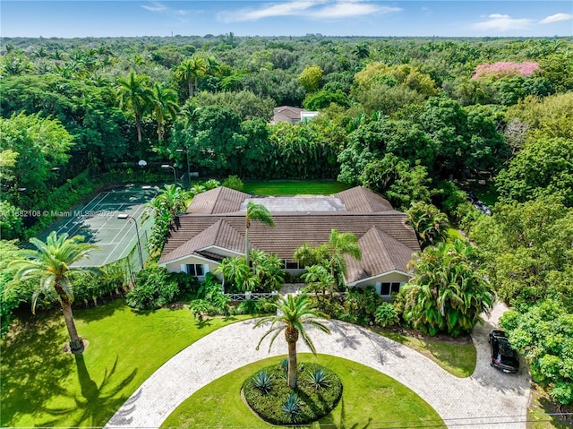 birds eye view of property with a view of trees