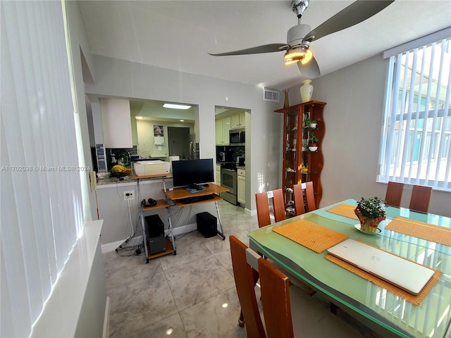 dining area with ceiling fan and light tile patterned flooring