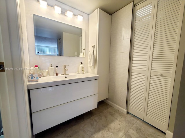 bathroom featuring decorative backsplash, vanity, and tile patterned flooring