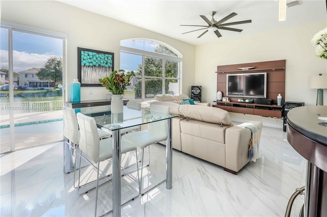 living room featuring a water view and ceiling fan