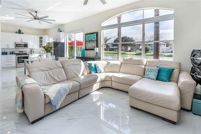 living room featuring plenty of natural light and ceiling fan