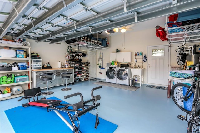 exercise area featuring separate washer and dryer and sink