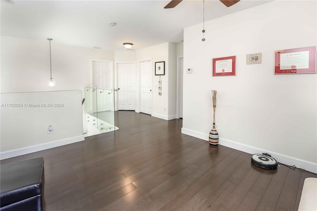 spare room with dark hardwood / wood-style flooring and ceiling fan