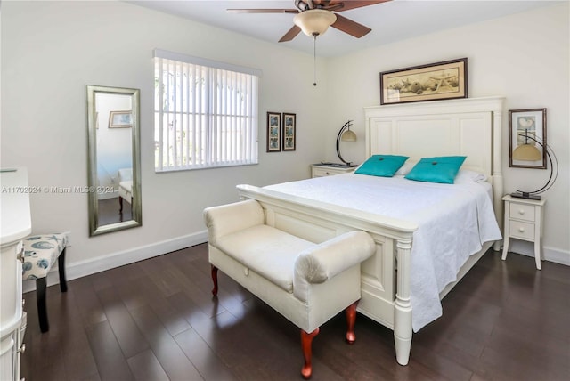 bedroom with dark hardwood / wood-style flooring and ceiling fan