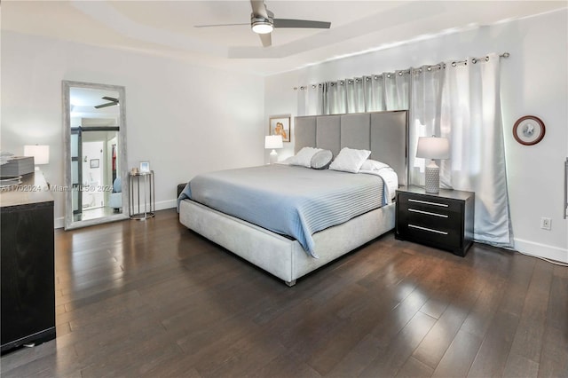 bedroom with dark hardwood / wood-style flooring and ceiling fan