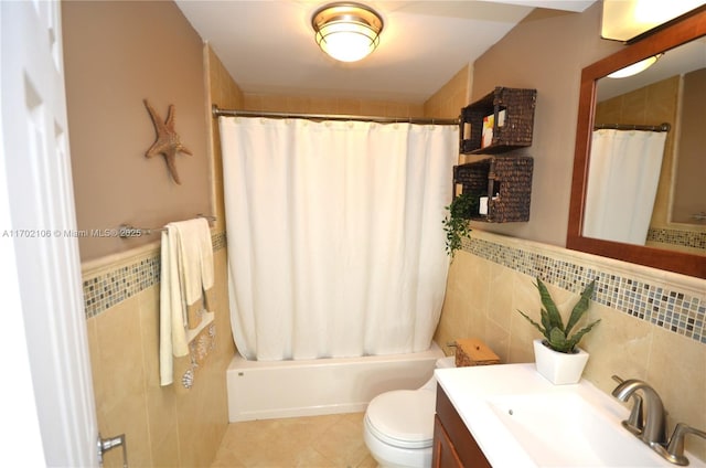 full bathroom with tile patterned flooring, shower / bathtub combination with curtain, tile walls, and toilet