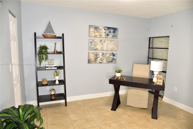 office space featuring baseboards and light tile patterned floors