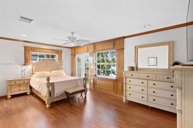 bedroom with hardwood / wood-style floors, ceiling fan, and crown molding