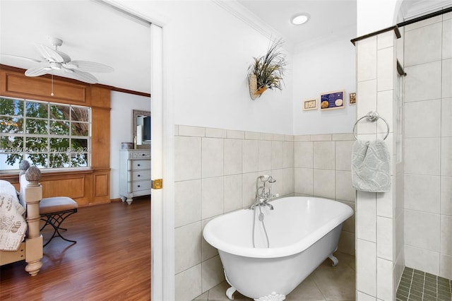 bathroom featuring ceiling fan, crown molding, tile walls, and hardwood / wood-style flooring