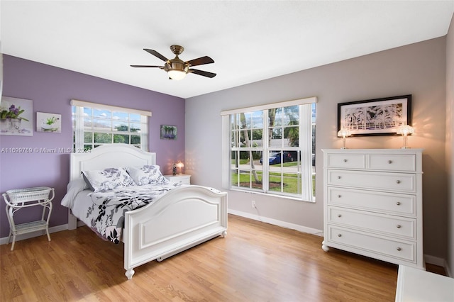 bedroom with ceiling fan and light hardwood / wood-style floors