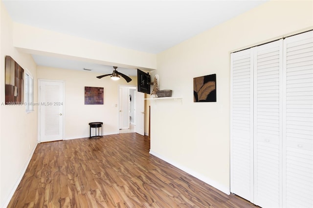 unfurnished living room with hardwood / wood-style floors and ceiling fan