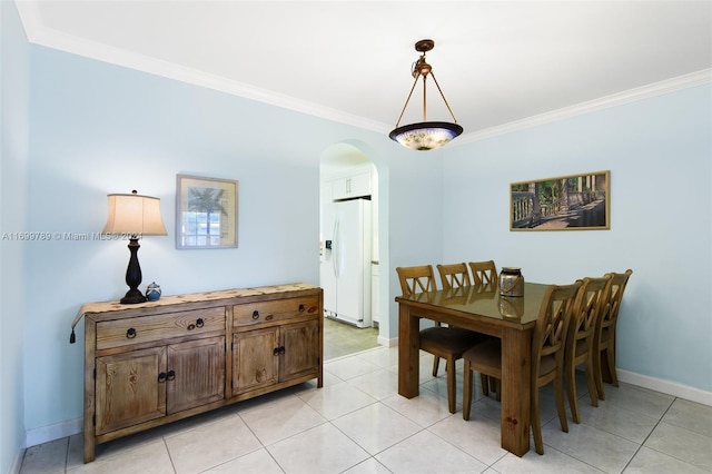 dining area with ornamental molding and light tile patterned floors