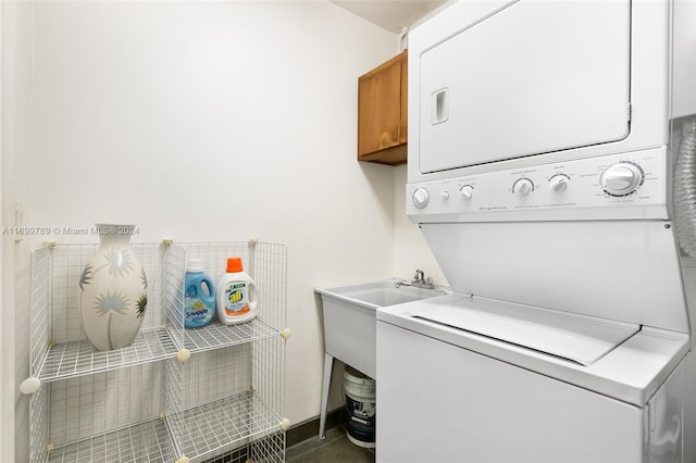 clothes washing area with stacked washer / dryer