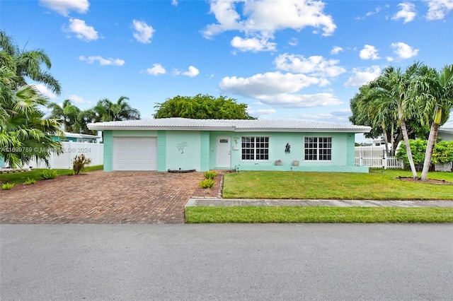 ranch-style house with a garage and a front lawn