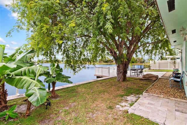 view of yard with a water view and a patio