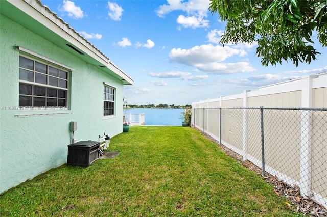 view of yard featuring cooling unit and a water view