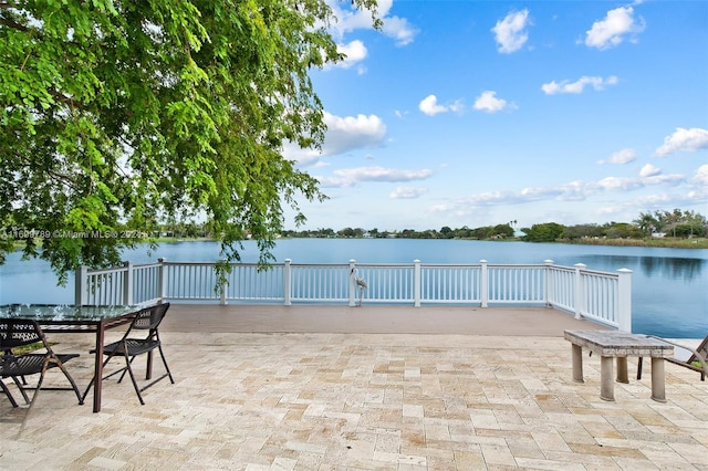 view of patio with a deck with water view