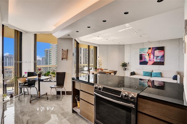 20191 E Country Club Dr Unit 2310, Aventura, FL 33180 - kitchen featuring dark countertops, rail lighting, stainless steel electric range, a view of city, and open floor plan