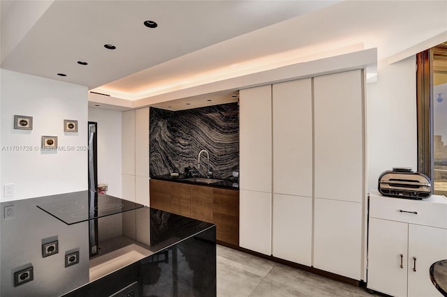 kitchen featuring white cabinets and black electric cooktop