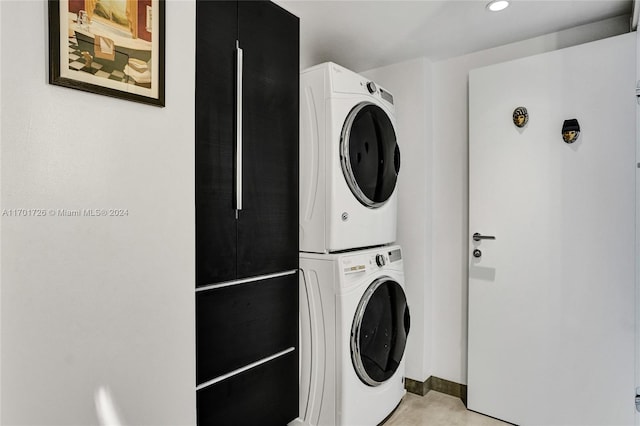 clothes washing area featuring stacked washer / drying machine