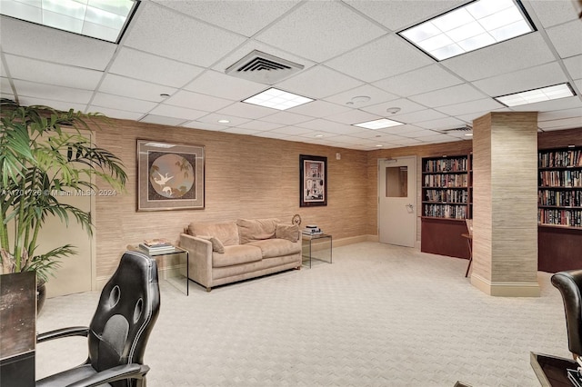 interior space featuring carpet floors and a paneled ceiling