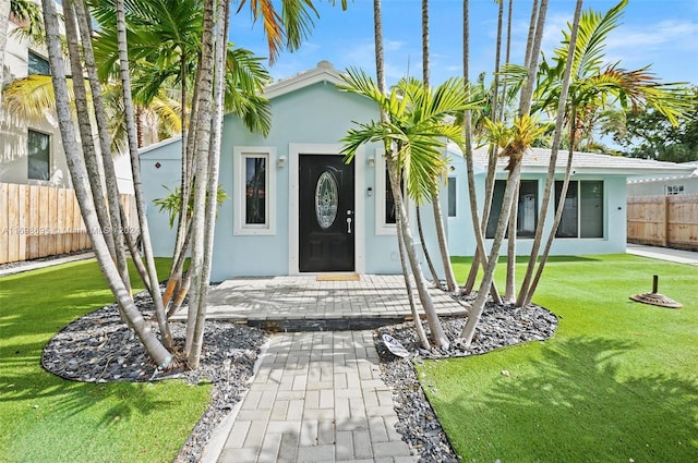 entrance to property featuring a yard