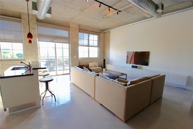 living room featuring plenty of natural light and sink