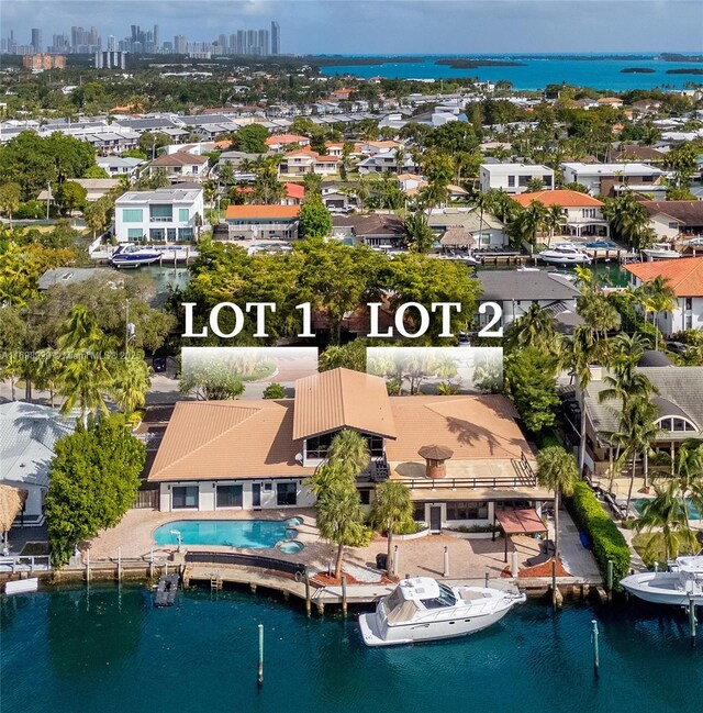 2010 NE 120th Rd, North Miami, FL 33181 - aerial view of residential area featuring a nearby body of water, skyline, and a pool