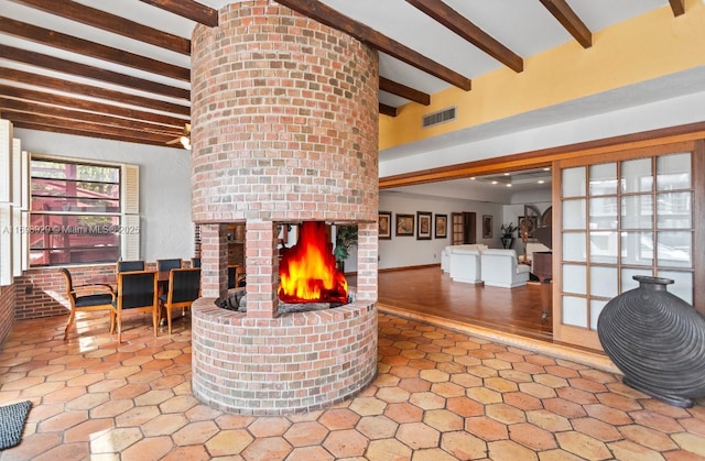 2010 NE 120th Rd, North Miami, FL 33181 - living area featuring beamed ceiling and a fireplace