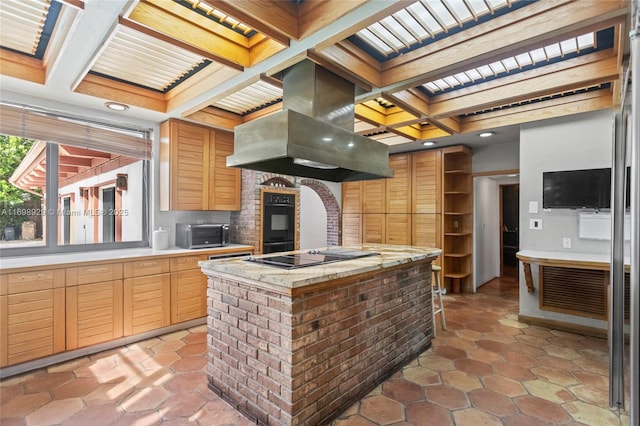 kitchen with coffered ceiling, island range hood, a center island, beamed ceiling, and black appliances