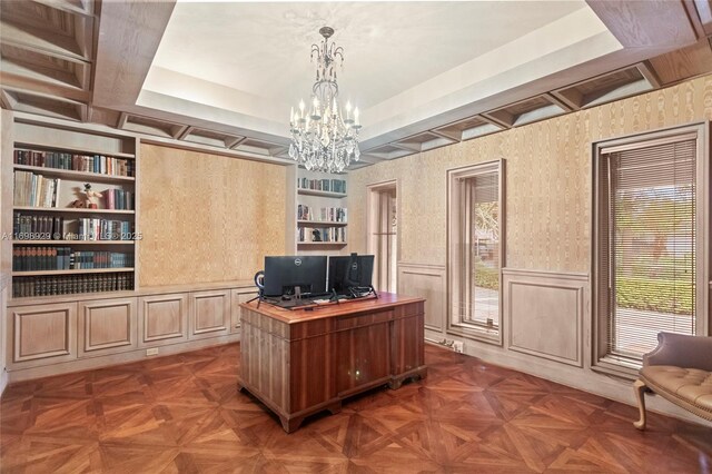 office featuring beamed ceiling, dark parquet flooring, an inviting chandelier, and built in shelves