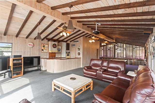 carpeted living room featuring ceiling fan, wood walls, and vaulted ceiling with beams