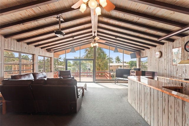 carpeted living room with lofted ceiling with beams, wooden walls, wooden ceiling, and ceiling fan