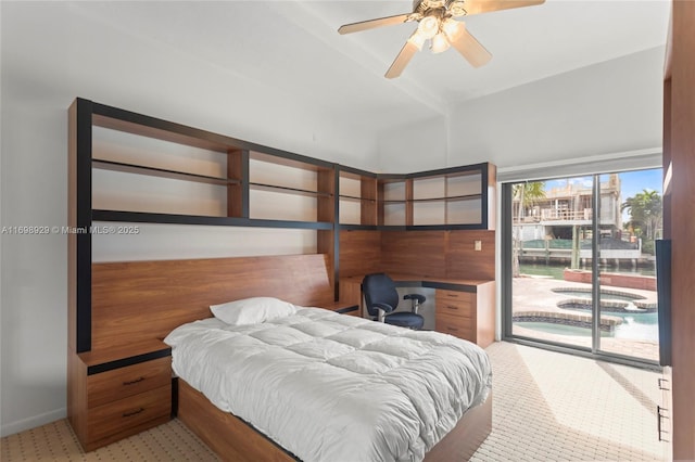 bedroom with access to outside, built in desk, and ceiling fan