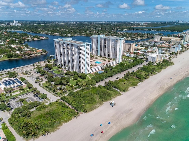 birds eye view of property featuring a water view and a beach view