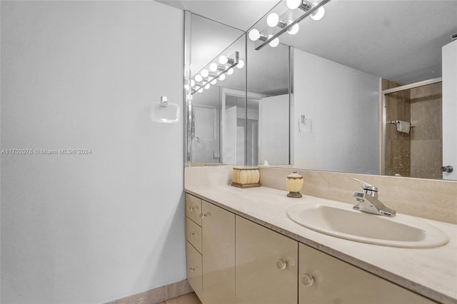 bathroom featuring vanity and an enclosed shower