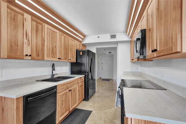 kitchen featuring light brown cabinets, sink, and black appliances