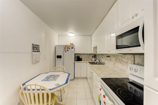 1849 S Ocean Dr Unit 1412, Hallandale Beach, FL 33009 - kitchen featuring white appliances, light tile patterned floors, white cabinets, light countertops, and tasteful backsplash