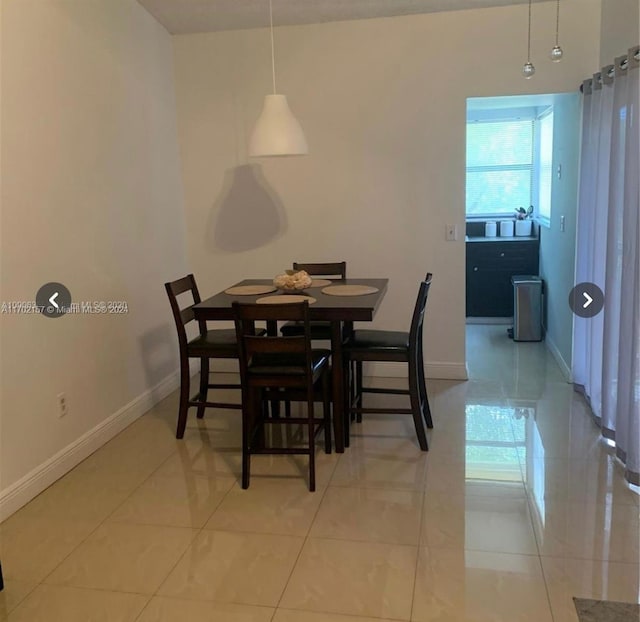 dining space featuring light tile patterned floors