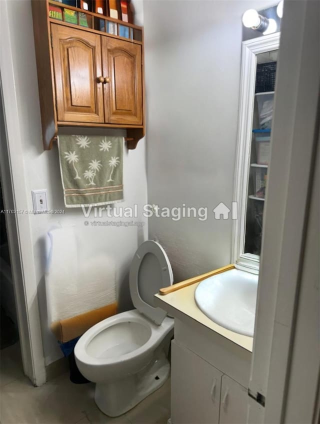 bathroom featuring vanity and toilet