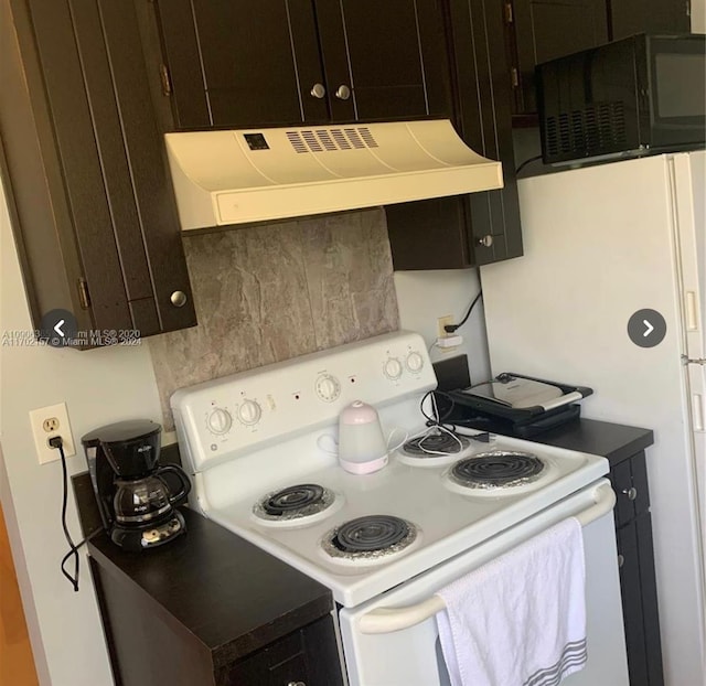 kitchen with dark brown cabinets, white range with electric stovetop, tasteful backsplash, and extractor fan