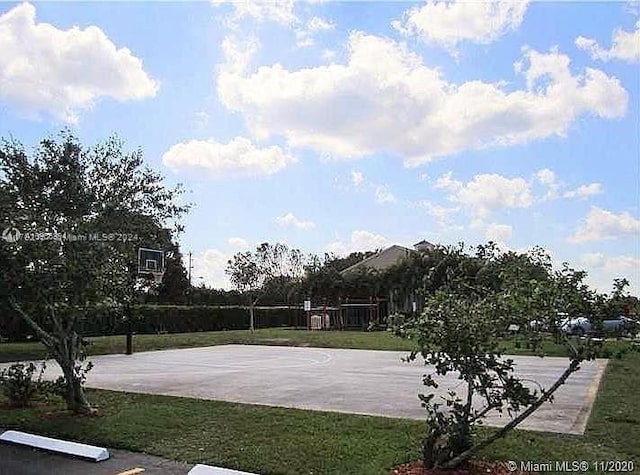 view of basketball court featuring a lawn