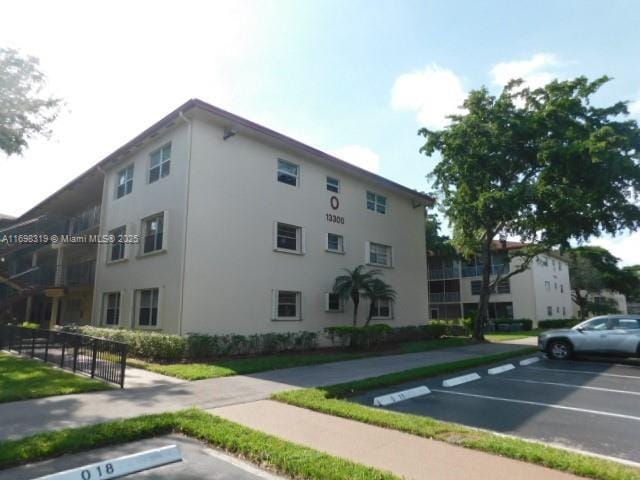view of building exterior featuring uncovered parking